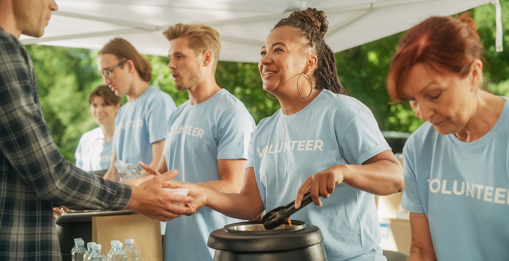 A group of volunteers handing out food. 