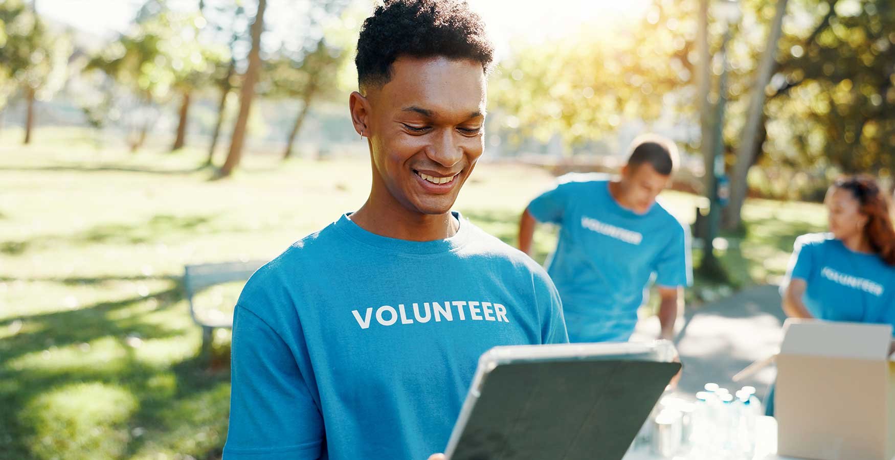 Volunteer smiling and holding clipboard. 