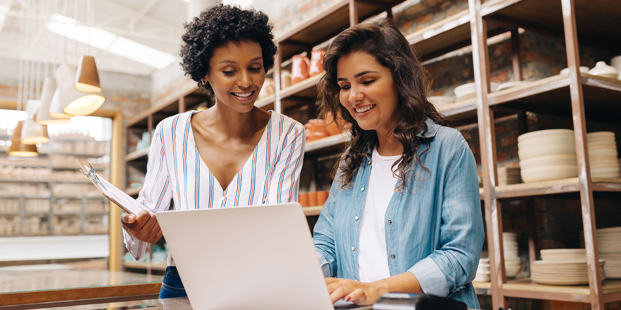 Two women looking at computer. 