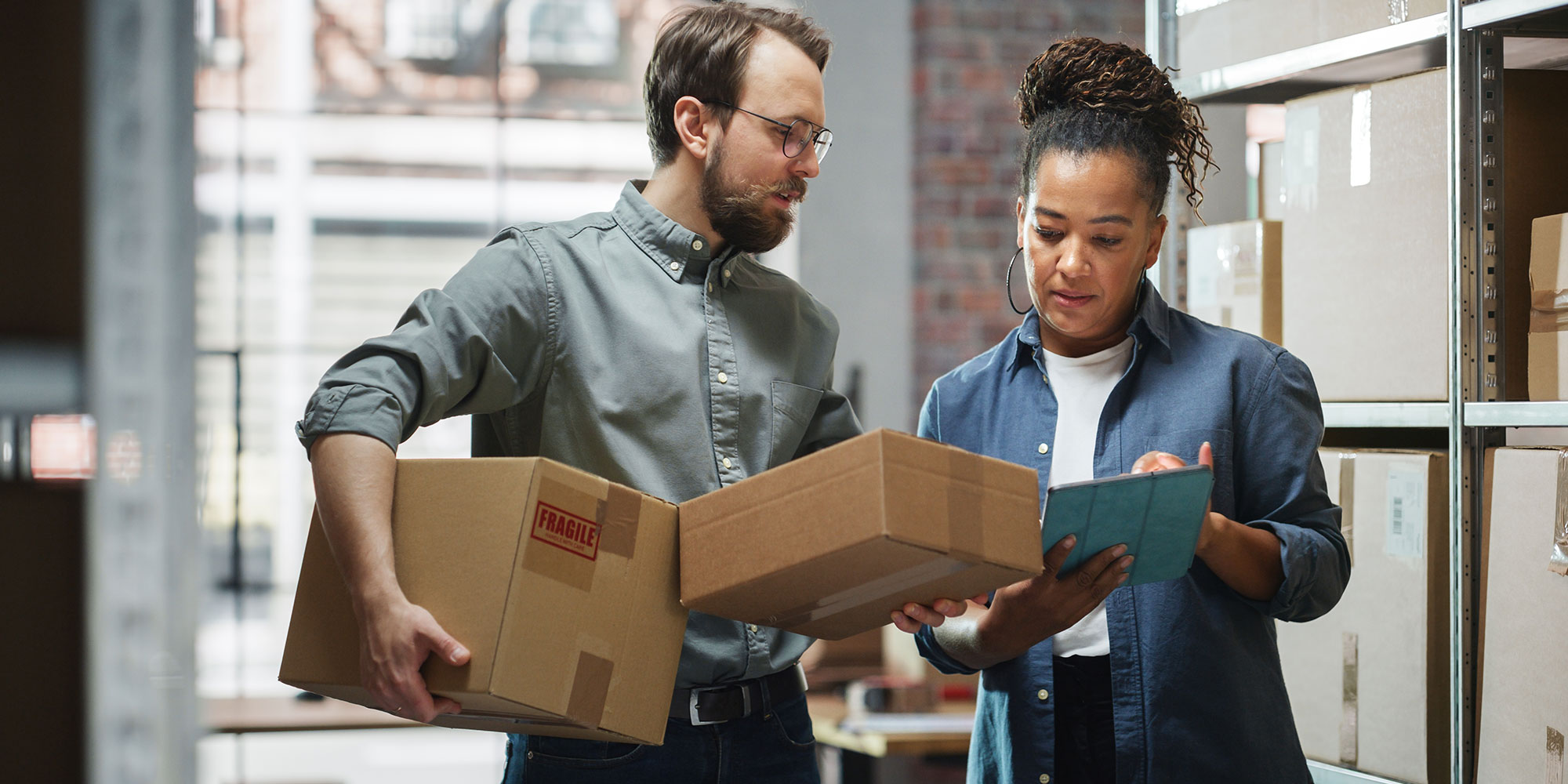 Man delivering packages and woman checking them.
