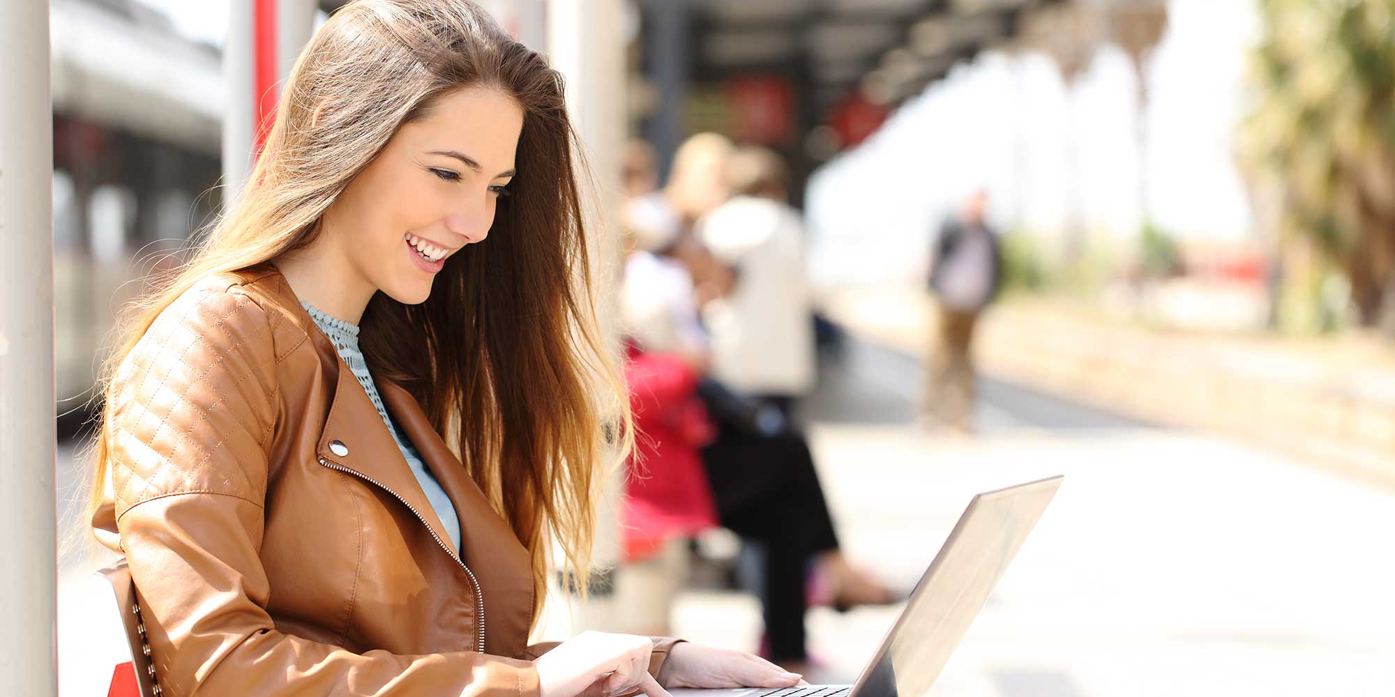 Girl smiling at her laptop. 