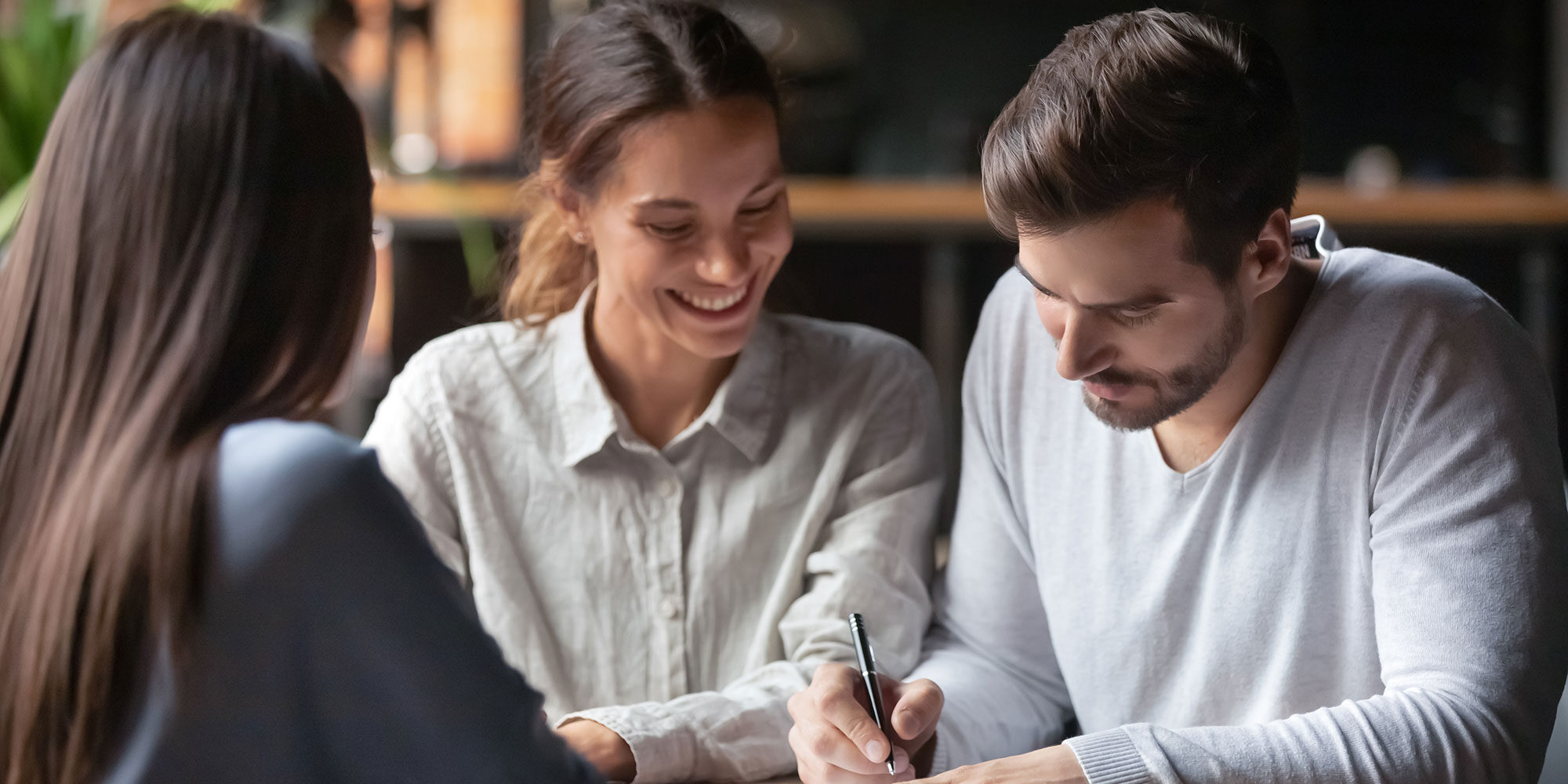Couple reviewing investments with a financial advisor.