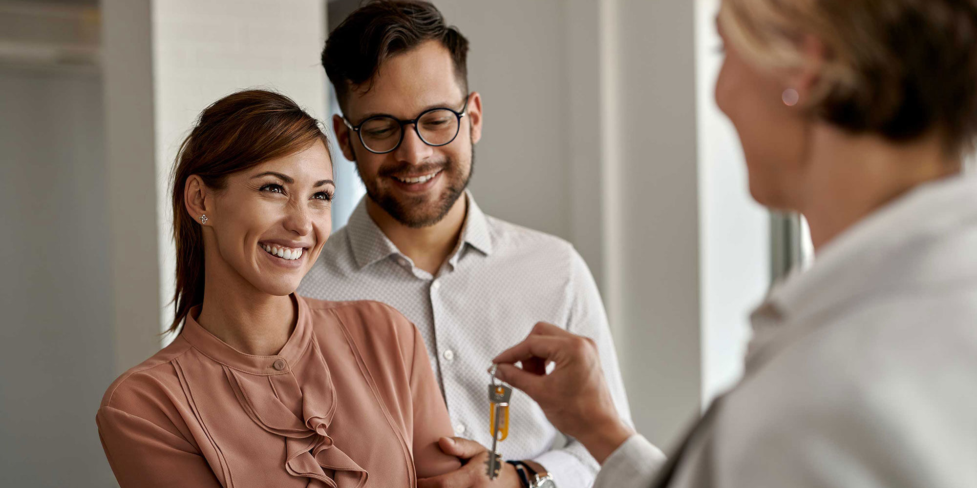 Couple receiving the keys to their new house.