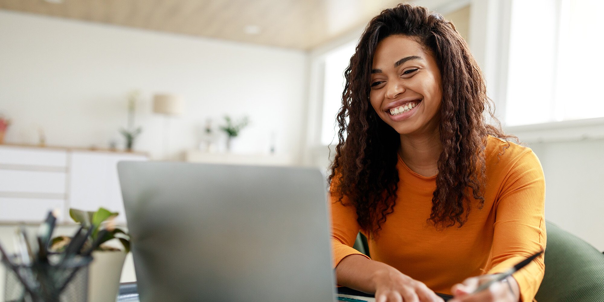 Smiling girl working on her computer. 