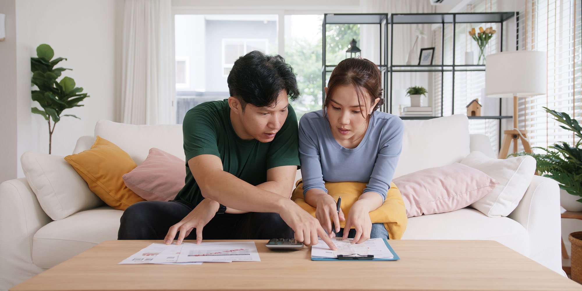 Couple reviews financial documents together at home.