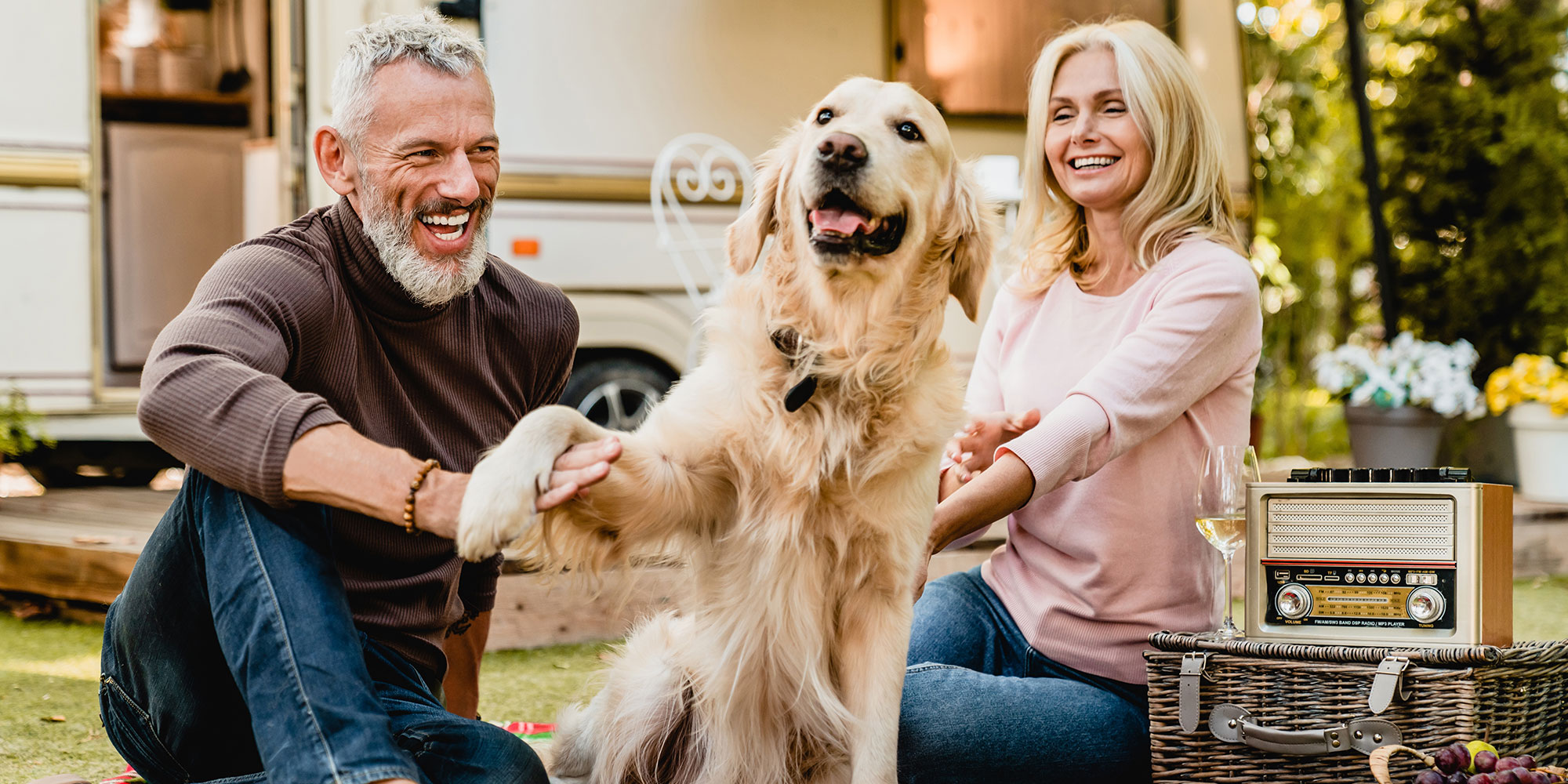 Old couple with their golden retriever. 