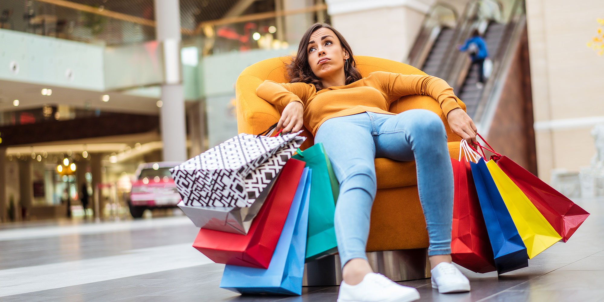 Woman holding lots of shopping bags.